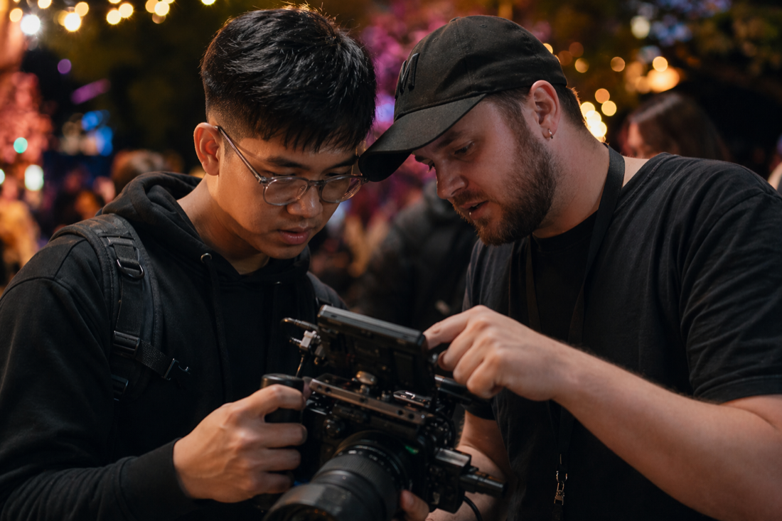 Camera operator filming an evening brand event